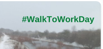 Green hashtag #WalkToWorkDay on a picture of grey sky above a misty river